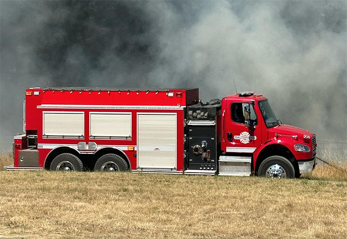 Firefighters contain blaze at hay field